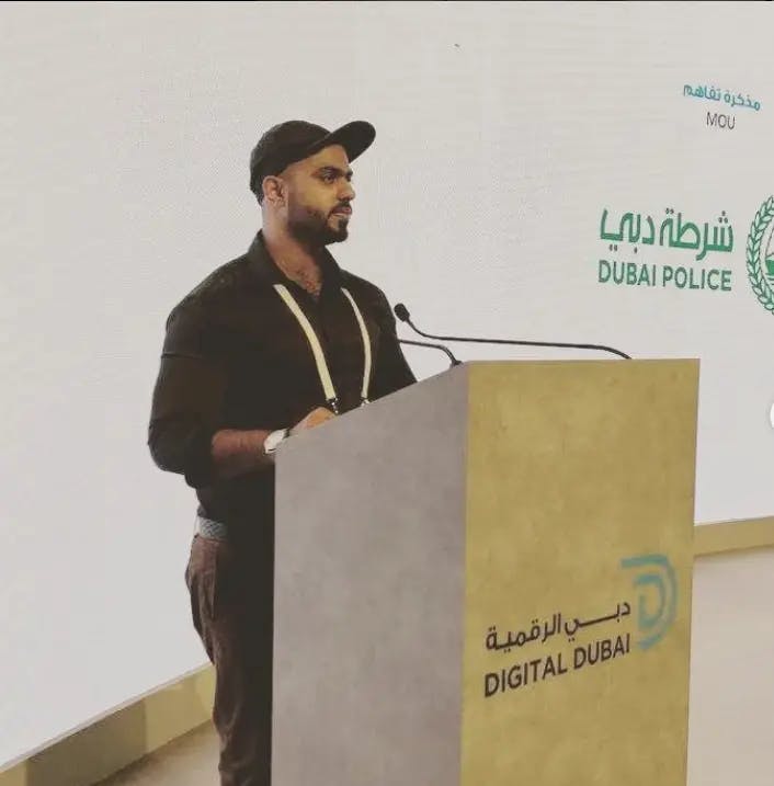 Speaking on stage at Dubai police station during a presentation